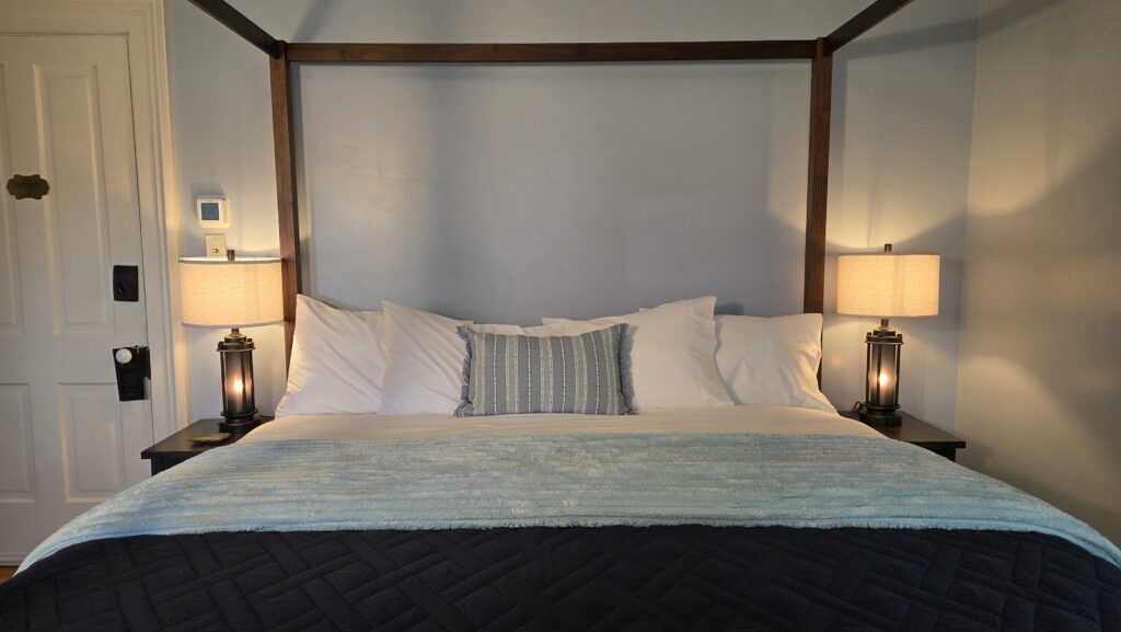 Lighthouse room at the Goose Crown Inn in Stoughton; canopy king bed with lantern-style bedside lamps
