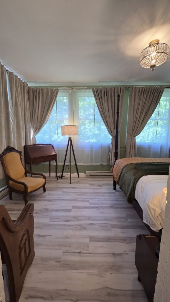 Sun room king suite with treetop views and birch floors, in a Victorian inn in Stoughton Wisconsin; The Goose Crown Inn