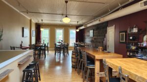 Wine tasting room in Stoughton, WI, at Cheesers. Comfortable seating with a view onto Main Street shown. The Goose Crown Inn.