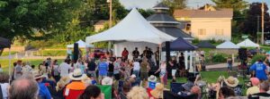 The Jimmys play to a crowd of people at the Catfish River Music Festival in Stoughton, Wisconsin; the Goose Crown Inn