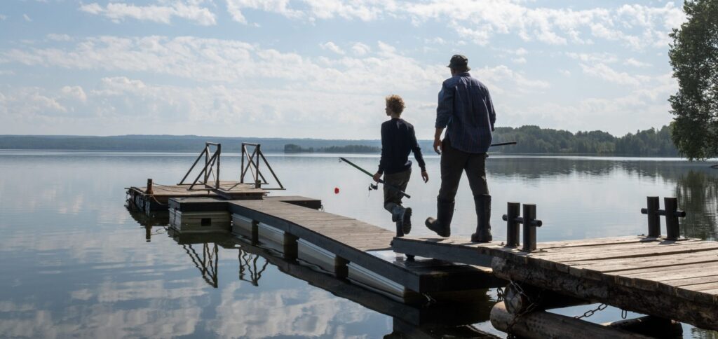 Fishing on a lake near Stoughton Wisconsin - a father and son head out on the dock of a peaceful lake; the Goose Crown Inn