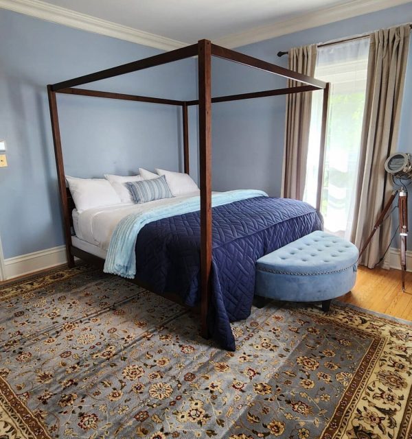 Canopy king bed in light-blue room with nautical themes; the Goose Crown Inn