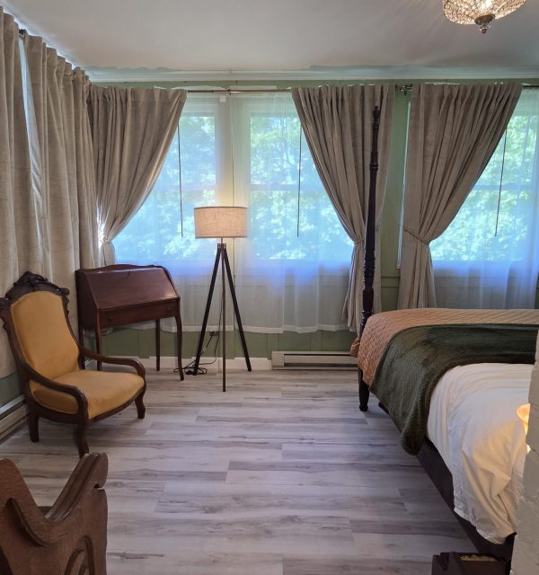 Sun room king suite with treetop views and birch floors, in a Victorian inn in Stoughton Wisconsin; The Goose Crown Inn